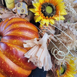 close up of arm, sunflower, and pumpkin