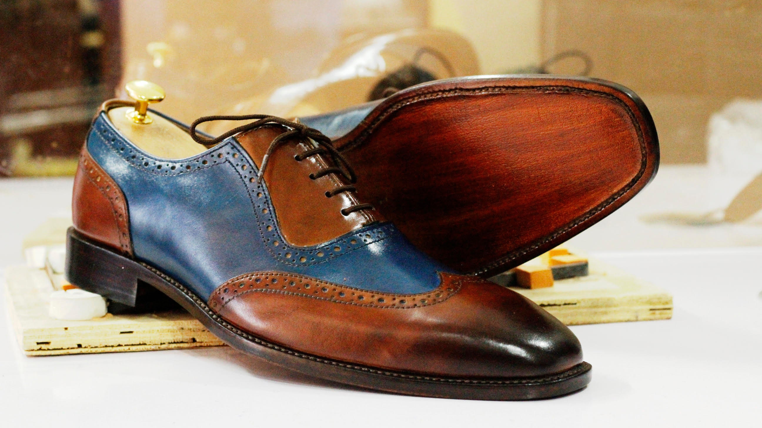 brown and blue wingtip shoes