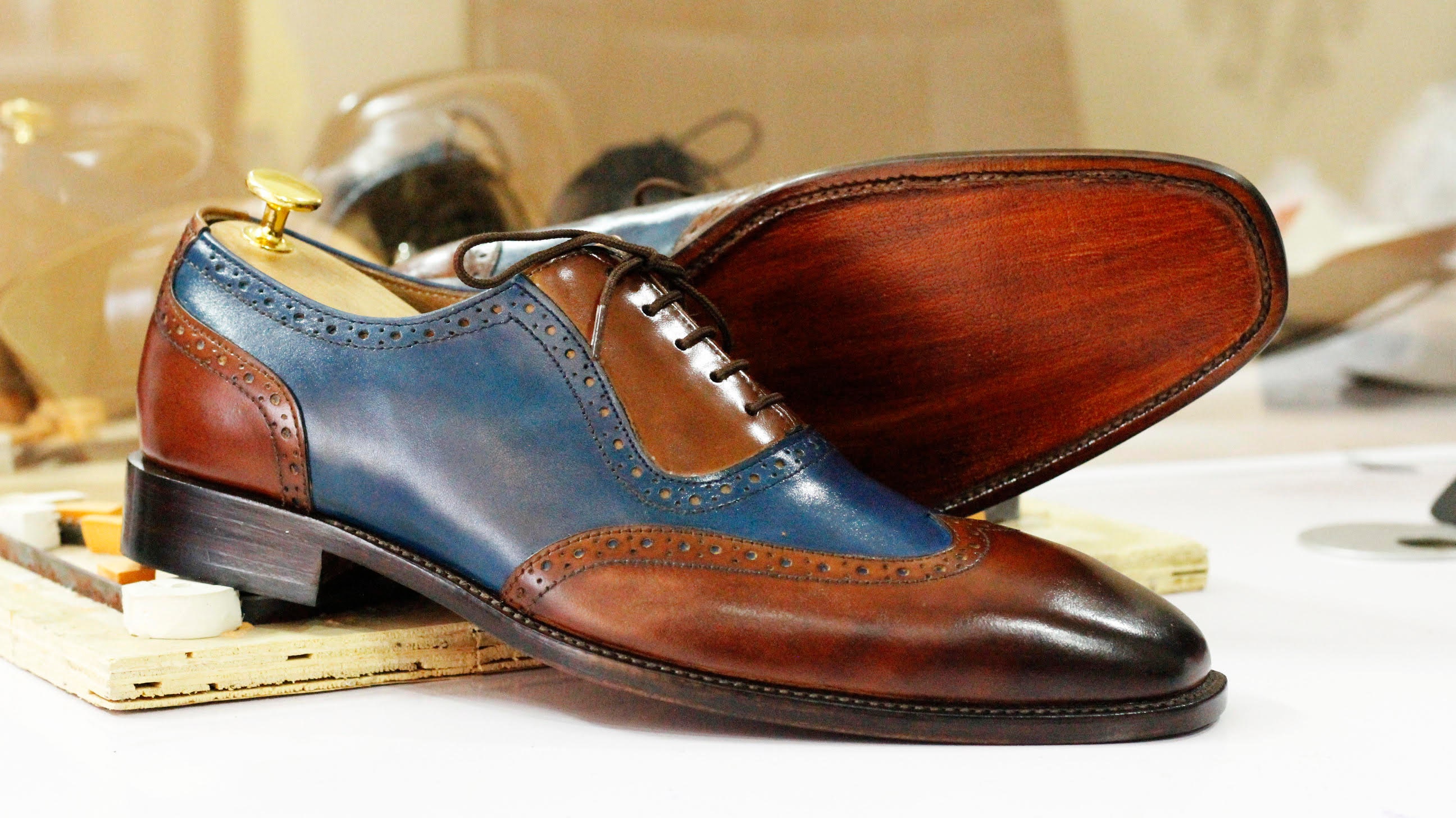 brown and blue wingtip shoes