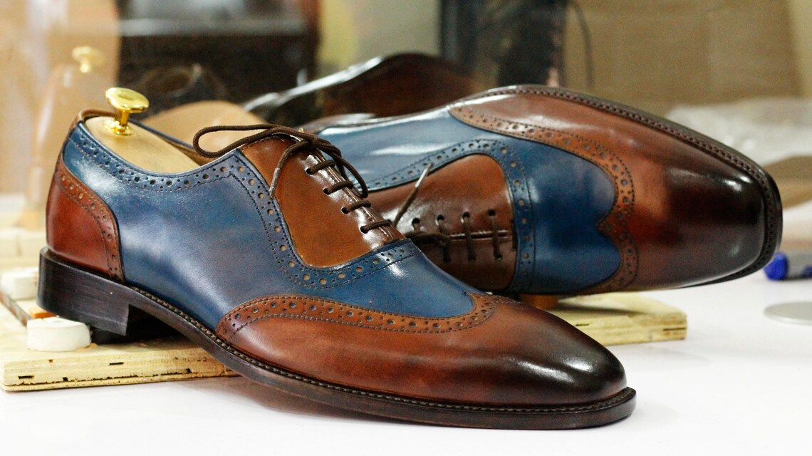 brown and blue wingtip shoes