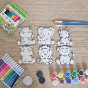 May include: A set of six wooden animal-shaped paint-by-number kits. The animals are a zebra, a hippopotamus, a lion, a monkey, an elephant, and a giraffe. The kits come with paintbrushes, paints, and a wooden stand.
