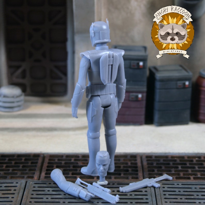 May include: A grey unpainted resin action figure of a warrior in armour with a jetpack, standing upright. Included are an additional detached head, a separate arm holding a blaster rifle, and a standalone blaster rifle, all in matching grey resin.