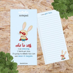 May include: A light blue magnetic notepad featuring a superhero bunny illustration and the words "magnetic notepad". The notepad has a grid pattern and the text "note to self: I am amazing. I have got this. I'm going to smash this list and make it happen."