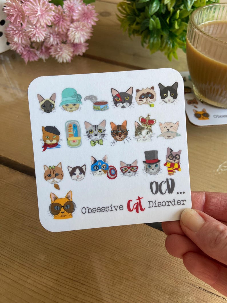 May include: White coaster with a colorful illustration of 18 cats with different accessories and expressions. The text "OCD... Obsessive Cat Disorder" is at the bottom of the coaster.