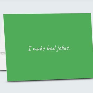 May include: A green card with the text "I make bad jokes." written in white cursive.