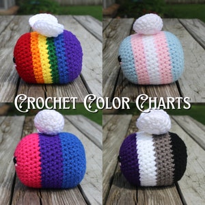 May include: Four crocheted bee plushies with different coloured stripes representing various pride flags. The bees are sitting on a wooden surface. The flags represented are: rainbow, transgender, bisexual, and asexual.