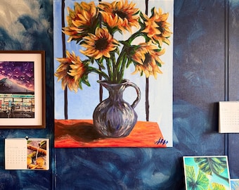 May include: A painting of sunflowers in a dark blue vase on a red table. The sunflowers are yellow and orange, with green stems. The background is a blue sky with vertical lines. The painting is hanging on a blue wall.