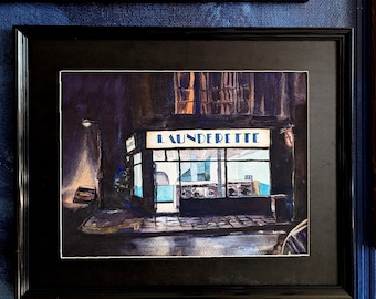 May include: A watercolor painting of a laundromat at night. The sign above the storefront reads "Launderette". The windows are lit up, and there are washing machines visible inside.