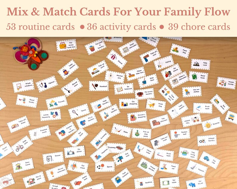 May include: A set of colorful cards with illustrations and text for a family game. The cards are scattered on a wooden surface. The text on the cards includes "Mix & Match Cards For Your Family Flow", "53 routine cards", "36 activity cards", and "39 chore cards".
