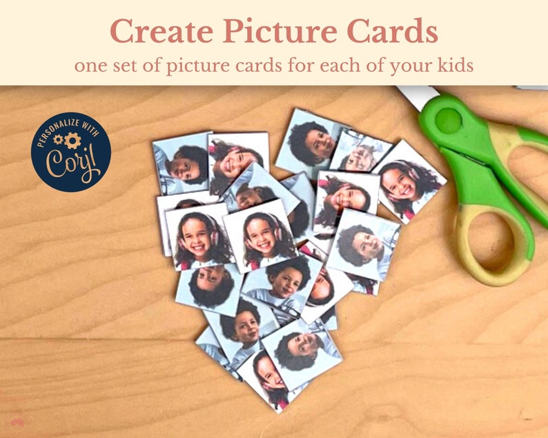 May include: A set of picture cards featuring different children's faces. The cards are arranged in a heart shape on a wooden surface. A pair of green scissors is visible in the top right corner of the image.