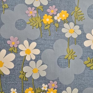 Retro daisy wipe-clean fabric in blue with white and yellow flowers