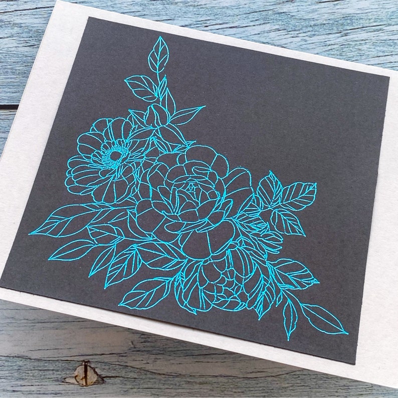 May include: A black card with a blue floral design. The design features a cluster of roses and leaves in the corner of the card.