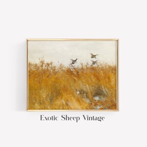 May include: A vintage painting of a golden field with a flock of ducks flying over it. The painting is framed in a gold frame.