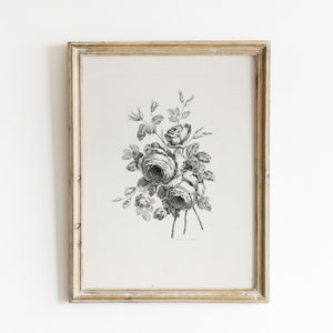 May include: A black and white vintage illustration of a bouquet of roses in a simple frame. The roses are drawn in a detailed style with delicate petals and leaves.
