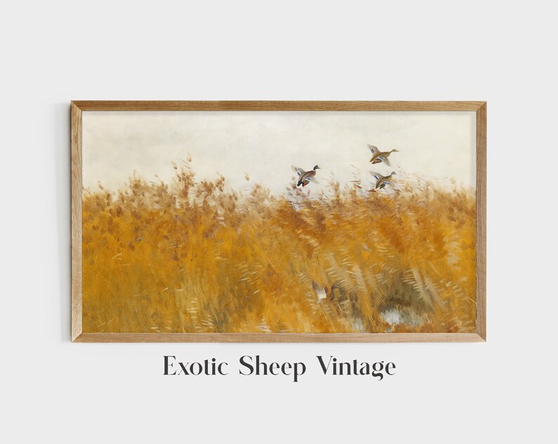 May include: A vintage painting of a field of tall, golden grass with a flock of ducks flying overhead. The ducks are in flight, with their wings spread wide. The painting is framed in a simple wooden frame.