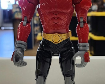 May include: Red Power Ranger action figure with a black and gold helmet and a black and silver suit. The figure has articulated arms and legs.
