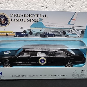 May include: A black die-cast metal Presidential Limousine toy car in a blue and white box. The box features an image of Air Force One and the text "Presidential Limousine". The toy car has free wheel action and authentic details.