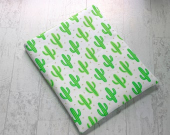 May include: White fabric with a repeating pattern of green cactus plants. The cactus plants are outlined in a darker green color.