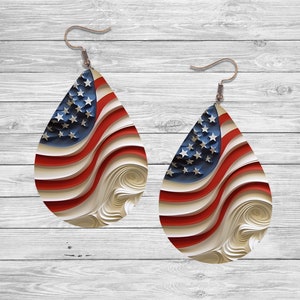 May include: A pair of teardrop-shaped earrings with a red, white, and blue American flag design. The flag is stylized with wavy lines and a 3D effect.