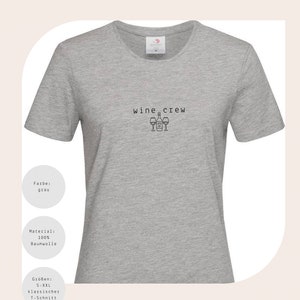 May include: Grey t-shirt with the text "wine crew" and a graphic of wine bottles and glasses.
