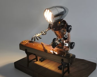 May include: A steampunk-style lamp shaped like a robot playing a guzheng, a Chinese musical instrument. The lamp is made of metal and has a silver and copper finish. The guzheng is made of wood and has a brown finish.