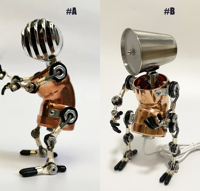 May include: Two robot figures made of metal and copper. The robot on the left has a silver microphone head and the robot on the right has a silver cup head. Both robots have copper bodies and silver joints.