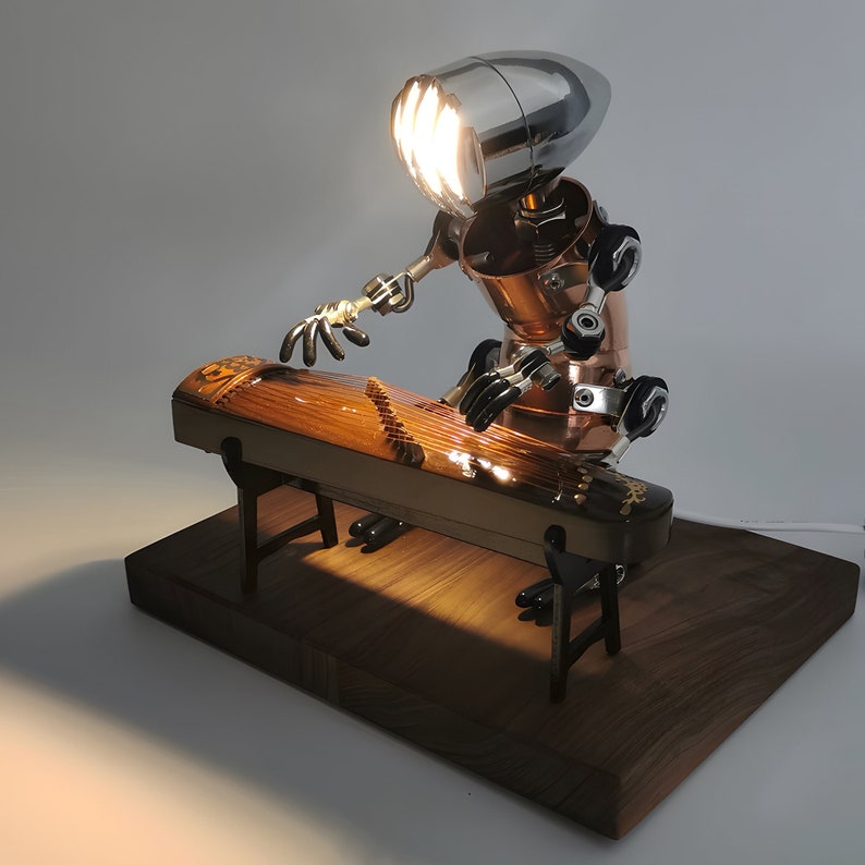 May include: A steampunk-style lamp shaped like a robot playing a guzheng, a Chinese musical instrument. The lamp is made of metal and has a silver and copper finish. The guzheng is made of wood and has a brown finish.