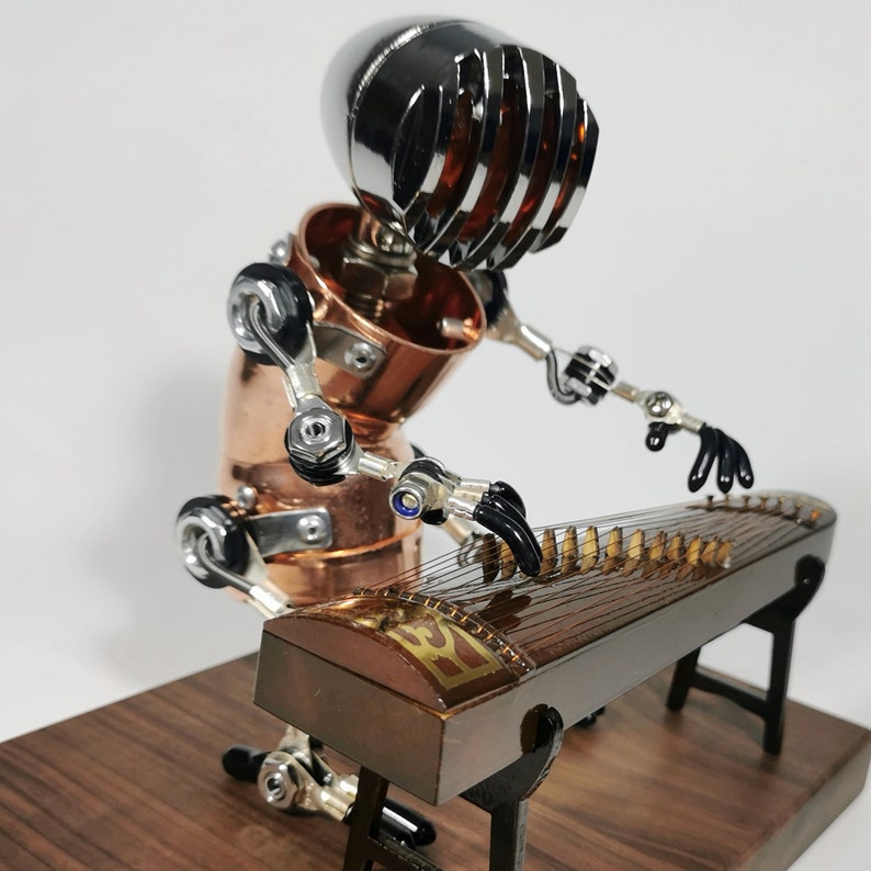 May include: A steampunk-style robot made of copper and metal parts plays a traditional Chinese zither, or guzheng, with black strings and a wooden body. The robot has a silver helmet with a grill design and black hands.