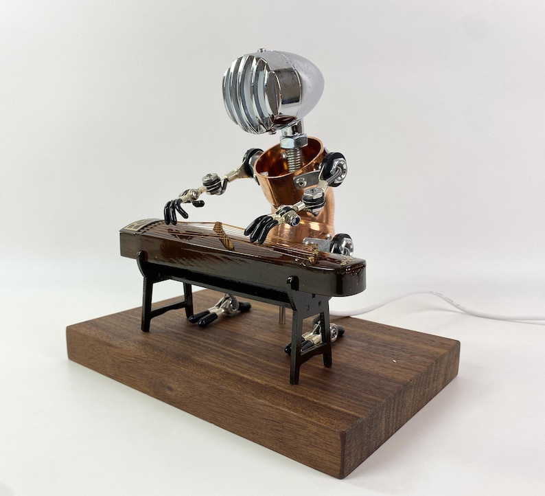 May include: A steampunk-style robot made of metal and wood plays a traditional Chinese zither, or guzheng, on a wooden base.