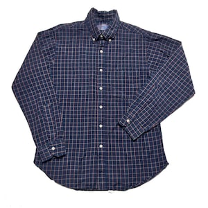 May include: A blue and red plaid long-sleeve button-down shirt.