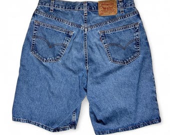 May include: Light blue denim shorts with a classic five-pocket design. The shorts feature a faded wash and a Levi Strauss & Co. leather patch on the back. The shorts have a button and zipper closure. The shorts measure approximately 12 inches in length.