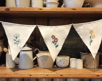 Wildflower embroidered bunting on vintage French linen