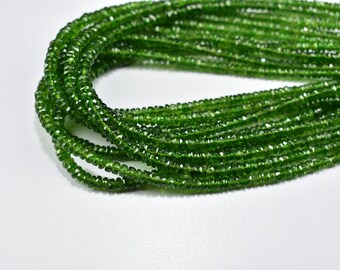 May include: A strand of green gemstone beads, likely peridot, with a faceted finish. The beads are small and uniform in size, creating a delicate and elegant look.