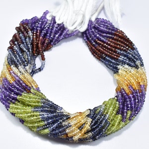 May include: A strand of multi-colored gemstone beads, including amethyst, peridot, citrine, and blue topaz. The beads are faceted and have a smooth, polished finish.