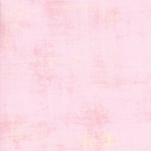 May include: A light pink textured background with a subtle, faded, white pattern.
