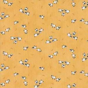 May include: A yellow fabric with a repeating pattern of white sheep. The sheep are facing different directions and some are clustered together.
