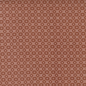 May include: A brown fabric with a white geometric pattern. The pattern is made up of small squares and circles.