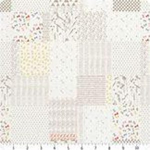 May include: A white fabric with a patchwork design featuring various patterns in shades of gray, beige, and yellow. The patterns include small floral motifs, stripes, and polka dots.