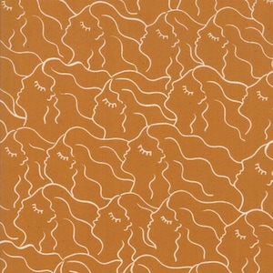 May include: Mustard-colored fabric with a repeating pattern of white line-drawn faces with closed eyes and flowing hair. The design creates a seamless, artistic texture, suitable for various craft projects or home decor.