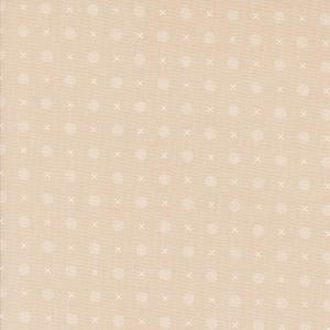 May include: A beige fabric with a repeating pattern of small white circles and white crosses.