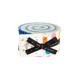 May include: A roll of colorful fabric with a white background and a geometric pattern of circles and lines. The fabric is tied with a black ribbon with gold stars and the text "Ruby Star Society Collaborative Collection" printed on a white tag.