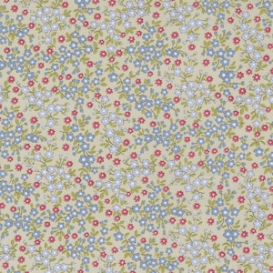 May include: A beige fabric with a repeating pattern of small blue and pink flowers. The flowers are arranged in clusters and are surrounded by green leaves.