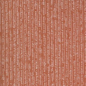 May include: A close-up of a brown, textured surface with the word "remarkable" printed in white. A black and gray stylus is lying on top of the surface.
