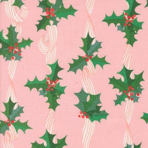 May include: Pink fabric with a repeating pattern of green holly leaves with red berries and white and pink striped ribbons. The design is a festive holiday theme.