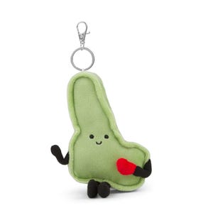 May include: A light green plush keychain shaped like an organ, with a smiling face, black arms and feet, and a red heart. The keychain has a silver metal clasp and ring.