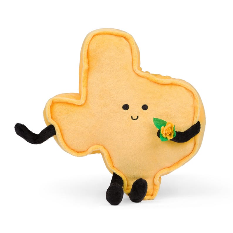 Puede incluir: Un peluche amarillo con forma de Texas. Tiene brazos y piernas negros, una cara sonriente y una peque&ntilde;a flor amarilla con hojas verdes. El juguete tiene un dise&ntilde;o amigable y de dibujos animados, ideal para ni&ntilde;os o como objeto decorativo.