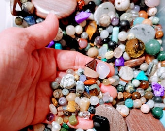 May include: A large assortment of colorful and natural gemstone beads, including amethyst, turquoise, agate, and jasper. The beads are in a variety of shapes and sizes, and are perfect for jewelry making or crafting.
