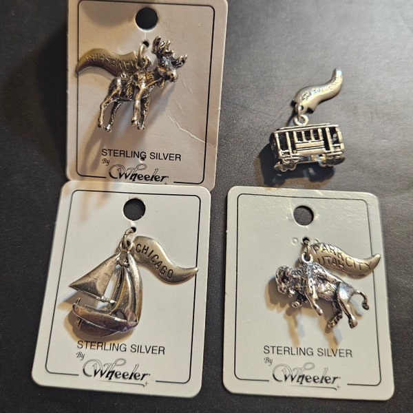 Wheeler Sterling Silver Souvenir Charms.  Boat, Buffalo, Moose, Streetcar. Unused, 3 still on Cards. Destinations on Attached Flags.