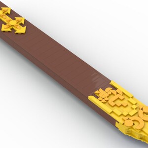 May include: A long, brown wooden stick with gold accents at each end. The accents are made of small, interlocking pieces that form intricate patterns.