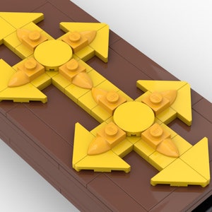 May include: Two yellow LEGO arrow pieces with a round yellow LEGO piece in the center of each. The arrows are pointing in four directions: up, down, left, and right. The LEGO pieces are on a brown surface.